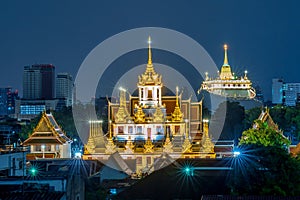 Wat Ratchanadda and Wat Saket that are decorated with colorful lights during the night