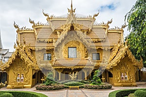 Wat Rong Khun The Abstract Golden Temple and pond with fish, in Chiang Rai, Thailand.