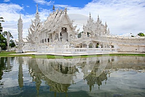 Wat Rong Khun temple reflection in water near Chiang Rai