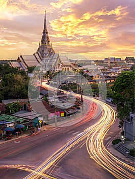 wat sothonwararam with light from a car and sunset