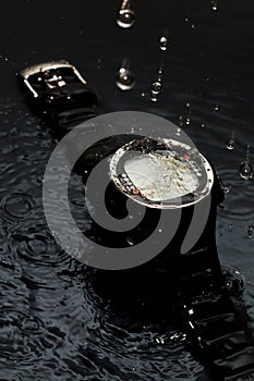 Watch computer for diving in water streams on a black background