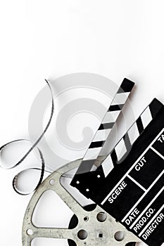 Watch film in cinema with video tape and clapperboard on white background top view