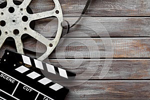 Watch film in cinema with video tape and clapperboard on wooden background top view