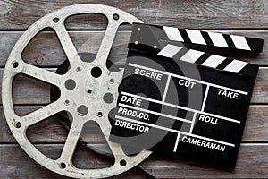 Watch film in cinema with video tape and clapperboard on wooden background top view