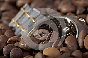 Watch in a heap coffee grains