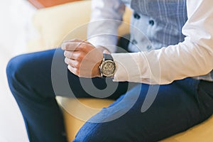 Watch on man`s hand. Groom preparing for wedding ceremony. Close-up shot