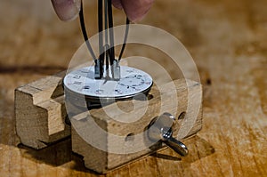 Watch Repair: Hands Remover About to Lift The Hands from a Pocket Watch Movement