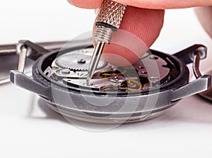 Watch repairer repairs old watch close up