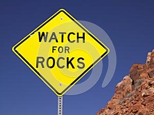 Watch For Rocks Sign Next to Highway