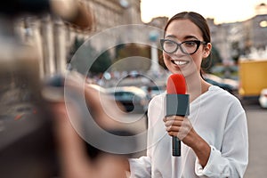 Watch us work for you. TV reporter presenting the news outdoors. Journalism industry, live streaming concept.
