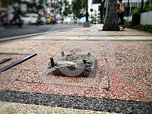 watch your step. on pedestrian walk, we also must be careful of this kind of obstacle that surely will hurt our feet. photo