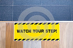 Watch Your Step Sign on the Floor