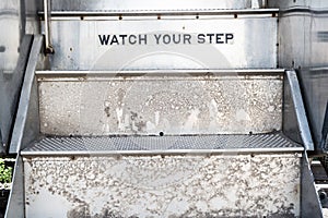 Watch your step sign on stairs