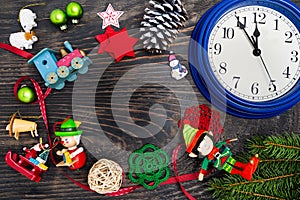 Watches, gifts, fir branches and decorations on a dark wooden background. Christmas composition. Christmas, winter, new year. Flat