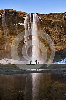 Watching in Awe, Rainbow in the spray off Seljalandsfoss Waterfall, Iceland