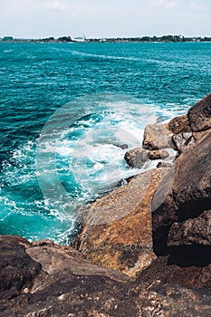 Watching beautiful blue waves breaking of big rocks. Stormy weather at sea. Stunning water color at peaceful landscape scene close