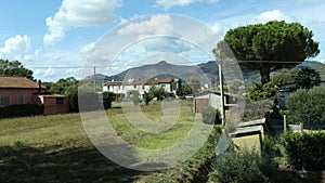 Watching from a car window as it travels an extra-urban road.