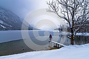 Watching the coming of a snow storm over frozen lake Bohinj in Slovenian Alps