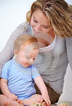 Watching her little man learn. an attarctive young woman and her adorable son.