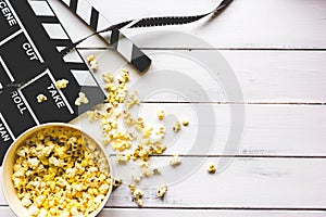 Watching movie with popcorn on wooden background top view