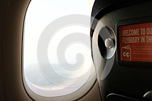 Watching through the plane window. Concept of travel, vacation and adventure.