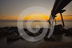 Watching sunrise while I photograph the Pont del Petroli of Badalona Barcelona Spain photo