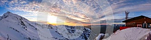 Watching sunset from Aibga mountain peak covered by snow. Gorki Gorod ski resort. Sochi, Russia