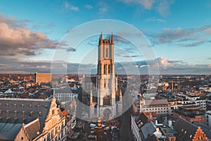 Watching the sunset over Ghent from the historic tower in the city centre. Romantic colours in the sky. Red light illuminating