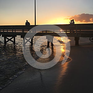 Watching the sunset from a pier