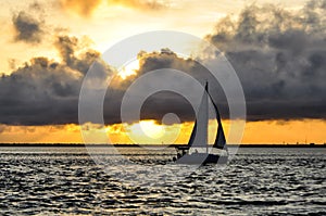 Watching the sunset while sailing photo