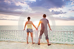 Watching together sunset at the ocean