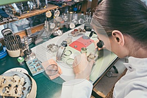 Watchmaker absorbed in her delicate work photo