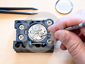 Watchmaker fixes mechanism of mechanical watch