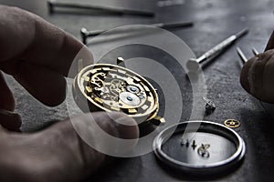 Watchmaker is repairing the mechanical watches in his workshop