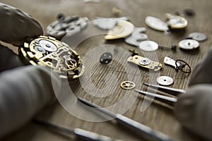 Watchmaker is repairing the mechanical watches in his workshop