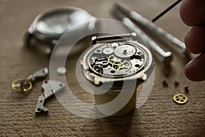 Watchmaker is repairing the mechanical watches in his workshop