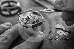 Watchmaker is repairing the mechanical watches in his workshop