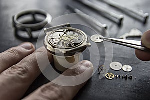 Watchmaker is repairing the mechanical watches in his workshop