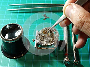 Watchmaker repairing watch