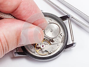 Watchmaker repairs old watch close up