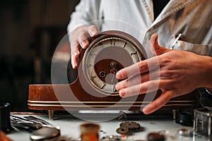 Watchmaker restore old wooden table clock