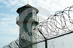 watchtower with barbed wire fence, security theme.