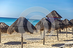 Watchtower of beach watchmen in the Caribbean with lines of umbrellas. Sea watchtower and bathers on a caribbean. photo