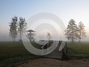 Watchtower Lookout at Beautiful Nature Wild Landscape Sunrise with Foggy Mist