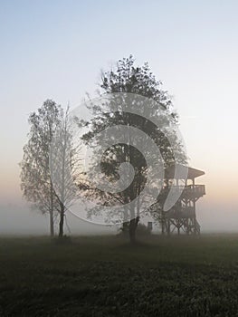 Watchtower Lookout at Beautiful Nature Wild Landscape Sunrise with Foggy Mist