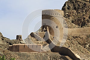 Watchtower with steps and mountains in Old Muscat