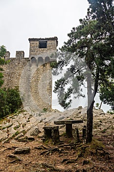 Watchtower on the wall surrounding Guaita Fortress in San Marino in the fog