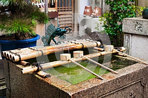 Water ablutions pavilion for a ceremonial purification at the Nishiki Tenmangu Shrine, Kyoto. Japan