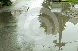 Water accumulate in the puddle on the asphalt road in the hole after heavy rain. photo