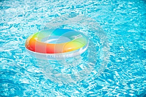 Water background. Pool float, ring floating in a refreshing blue swimming pool. Summer background.